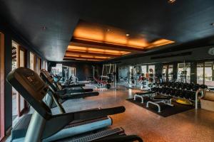 a gym with a lot of treadmills and machines at Pimalai Resort & Spa in Ko Lanta