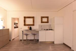 a kitchen with a table and two stools at Sweet Apartment in Venice