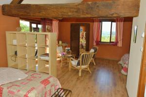 a bedroom with a bed and a table and chairs at La Parenthèse in Saint-Genix-sur-Guiers