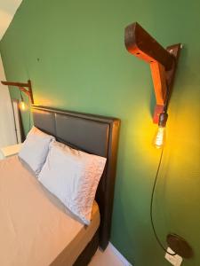 a bedroom with a bed with a light on the wall at Loft Luiz Gonzaga in Campina Grande