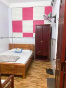 a bedroom with a bed with a book on it at MyDungmotel in Danang +2 photos