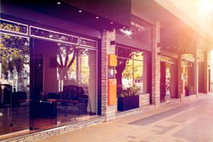 a store front with glass windows and a person sitting at a table at Bonito Hotel in San Rafael
