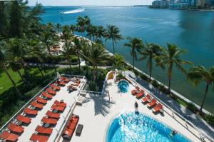 an aerial view of a resort with a pool and chairs at Mandarin Oriental Miami in Miami