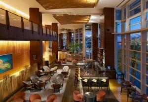 a restaurant with a bar with chairs and tables at Mandarin Oriental Miami in Miami