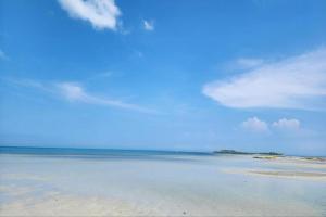 a view of a beach with the water and sky at Pertible Beach Resort in Tondol