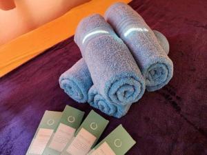 three rolled up towels sitting on a table next to some cards at Pertible Beach Resort in Tondol