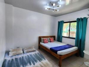 a bedroom with two beds and a window at Pertible Beach Resort in Tondol