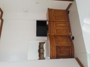 a room with a wooden door and a microwave at Andres Resort in Nabas