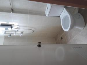 a bathroom with a toilet and a sink at Andres Resort in Nabas