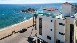 an aerial view of a building and the beach at Gangneung Dolgorae Spa Pension in Gangneung