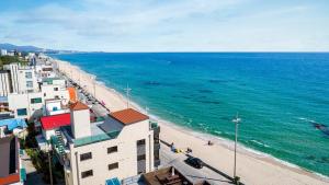 an aerial view of a beach and the ocean at Gangneung Dolgorae Spa Pension in Gangneung +18 photos