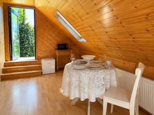 a dining room with a white table and chairs at Relaxing Loft Getaway Heart of County Meath in Enfield