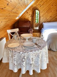 a table with plates and glasses on it in a bedroom at Relaxing Loft Getaway Heart of County Meath in Enfield