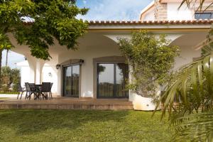 a patio of a house with two chairs on it at Quinta Vale do Armo in Sardoal