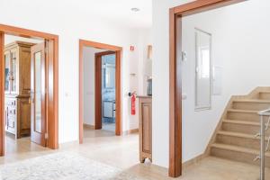 a room with a stairway and a hallway with a door at Quinta Vale do Armo in Sardoal