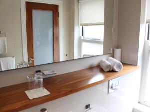 a white sink sitting under a window in a bathroom at The Lombard Townhouse in Dublin