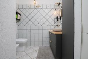 a bathroom with a toilet and a sink at Villetta Vespucci in Agrustos