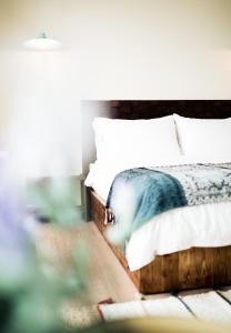 a bedroom with a bed with white pillows at Haku Beach Days Inn in Nanwan