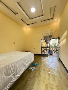 a bedroom with a white bed and a wooden floor at Addis View Homestay in Lalibela +10 photos