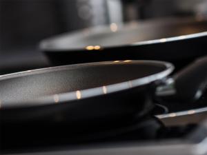 two pans sitting on top of a stove at Alpenapart Frank in Längenfeld +29 photos