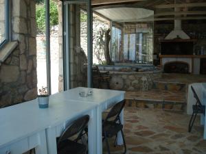 a room with a table and chairs and a fireplace at Merlot Village Rental Apartments in Kariá