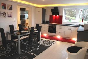 a kitchen with a dining room table with chairs and a stove at Fewo im Herzen von Unterfranken in Marktbreit +11 photos