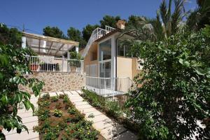 a house with a porch and some plants at Can Medina in Pollença
