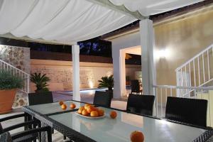 a table with a bowl of oranges on a patio at Can Medina in Pollença