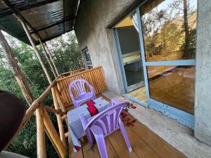 two purple chairs sitting on the porch of a house at Addis View Homestay in Lalibela