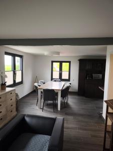 a dining room with a table and some chairs at Haus am Deich in Norden
