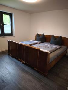 a large wooden bed in a room at Haus am Deich in Norden