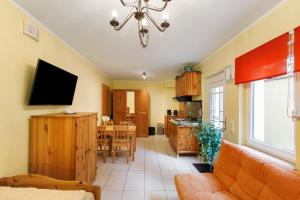 a living room with a couch and a dining room at Villa am Keltenberg - El Sol in Glauburg