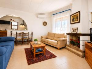 a living room with a couch and a table at Private Pool Villa La Siesta in La Mata