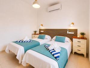 two beds in a room with white walls at Private Pool Villa La Siesta in La Mata +16 photos