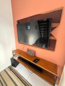 a flat screen tv hanging on a wall at Loft Luiz Gonzaga in Campina Grande