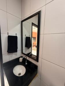 a bathroom with a sink and a mirror at Loft Luiz Gonzaga in Campina Grande +21 photos