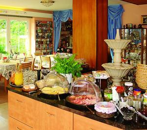 a kitchen with a counter with food on it at Hotel Garni Regina in Gößweinstein