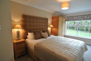 a bedroom with a large bed and a window at 2-Bedroom Windsor Apartment with Free Parking in Windsor