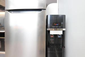 a stainless steel refrigerator in a kitchen next to at ST Signature Bugis Beach in Singapore