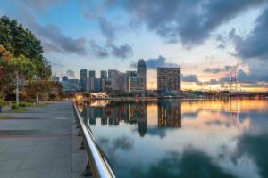 a view of a city skyline with a body of water at ST Signature Bugis Beach in Singapore