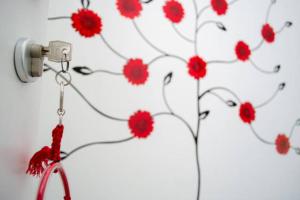 a bunch of red flowers on a wall at La Casa del Riccio in Tindari