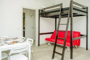 a room with a red chair and a bunk bed at La Casa del Riccio in Tindari