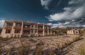 an old building in the middle of a field at Indus County in She
