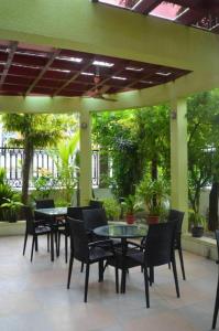 a group of tables and chairs on a patio at Vista Villa in Hithadhoo