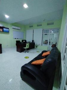 a living room with a couch in an office at Vista Villa in Hithadhoo +15 photos