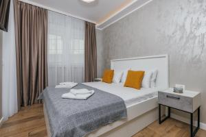 a bedroom with a large bed and a window at Apartments Via Mare in Petrovac na Moru