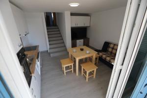 a small living room with a table and a couch at Apartman BARONI in Pinezici +14 photos