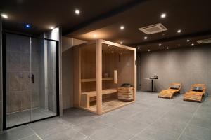 a bathroom with two chairs and a shower at Porpora Suite Hotel in Milan +18 photos