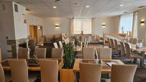 a dining room with tables and chairs in a room with at Motorest Štěpán in Těšov