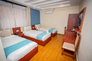 a hotel room with two beds and a television at Hotel AB Inn in Kathmandu +47 photos